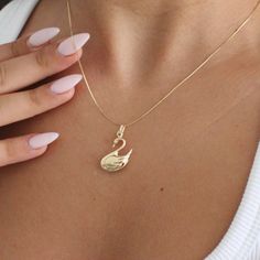 "14K Solid Gold Swan Necklace . . . * Pendants Measurements With Bail: (30 x 15 mm) * Chain is included ( 1MM Box Chain) * Stamp: Real 14k Gold * Never gold filled or plated * Hypoallergenic * Water Resistant * Scratch Resistant * Packaged With Free Gift Box . . . If you have any questions, just hit the \"Message the Seller\" button ( bottom right of the page) and we will get back to you within a few hours. . . . Mailed in a cute white package great for gifting. . . . Check our Social Media @Talajewel, and let's be friends! . . . . Made in USA, Swan Jewelry, Gift for animal lovers, Gift for bird lovers, Gold Swan Necklace, Swan Necklace, Necklace Charm, Can be worn with other necklaces, great for layers. A Perfect 14K Gold gift. Christmas Gift, Christmas gift for her, Christmas gift for hi Gold Plated Curb Chain Charm Necklace Gift, 14k Yellow Gold Charm Necklace With Box Chain, 14k Gold Charm Necklace With Box Chain, Elegant Charm Necklace With Curb Chain As Gift, Elegant Curb Chain Charm Necklace For Gift, Elegant Curb Chain Charm Necklace Gift, 14k Rose Gold Snake Chain Necklace, 14k Gold Box Chain Necklace For Anniversary, Gold Charm Necklace With Box Chain For Anniversary