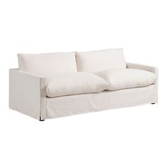 a white couch sitting on top of a wooden table