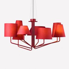 a red chandelier with five lamps hanging from it's sides and four shades on each side