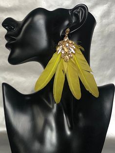 YELLOW GOLD DANGLE FEATHER ERRINGS WITH GOLD COLOURED RHINESTONES Ready to wear something spectacular which will elevate any outfit with chic? These gorgeous Feather earrings are exactly what you need. Add brightness and playfulness to the romantic dress, emphasize your exclusive look!  My accessories are entirely handmade and are therefore unique pieces which I hope provide customers with stylish, elegant, handmade accesories. Creating such unique accesories I always use high quality materials, Party Jewelry With Dangle Feathers, Party Jewelry With Feather Dangles, Party Feather Dangle Jewelry, Unique Luxury Yellow Earrings, Gold Feather Earrings For Party, Gold Feathered Jewelry For Parties, Elegant Yellow Tassel Earrings, Luxury Elegant Feather Jewelry, Elegant Brown Feather Earrings