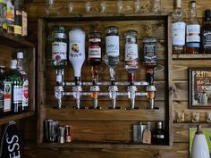 a wooden shelf filled with lots of bottles and glasses