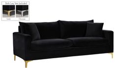 a black couch with gold legs and pillows