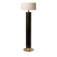 a black and gold floor lamp with a white shade on the top, standing in front of a white background