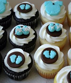 there are many cupcakes with blue and brown icing