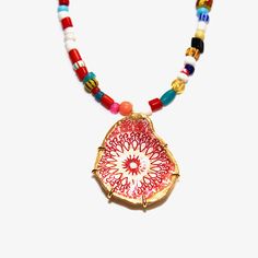 "This fun upcycled red medallion oyster shell necklace uses shells collected from the beaches of Wellfleet, Massachussets. They are decoupaged with fun, colorful papers. The backs and edges are painted with gold leaf paint and set in a gold vermeil prong setting with a Christmas Trade Bead necklace. The necklaces are not water resistant. This necklace measures 16-18\" without the shell drop. All shells come boxed and ready for gift giving. ❤️ Listing is for one shell . 🐚 Please Note: Oyster and Red Bohemian Shell Necklace For Gift, Artisan Red Necklace With Round Pendant, Shell-shaped Colorful Bead Necklaces For Gifts, Colorful Beads Shell Necklace For Gifts, Handmade Red Shell Necklace Gift, Handmade Red Shell Necklace For Gift, Red Amulet Beaded Necklaces With Colorful Beads, Handmade Red Medallion Necklace, Artisan Beaded Shell Necklace As Gift