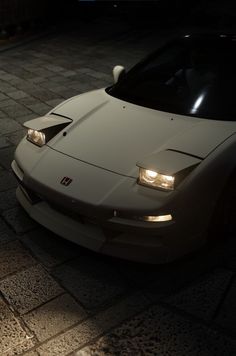 a white sports car parked in the dark