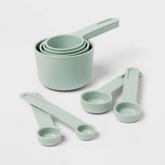 a set of green measuring cups and spoons