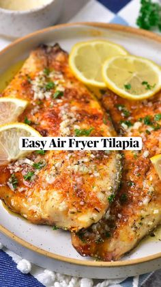 an image of air fryer tilapia with garlic butter on a plate and lemons