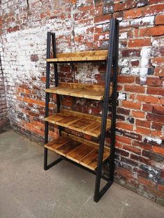 an industrial shelving unit stands against a brick wall