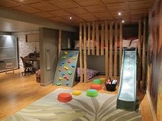 a kid's playroom with slide and climbing wall