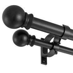 an image of two black curtain rods with ball and rod ends on the side of a white wall