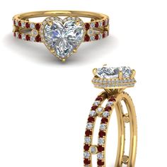 a heart shaped diamond ring with red and white stones on the sides, set in yellow gold