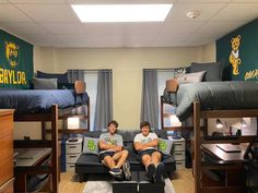 two young men sitting on bunk beds in a dorm room