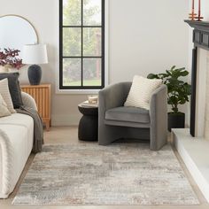 a living room filled with furniture and a fire place in front of a large window