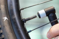 a close up of a person adjusting the spokes on a bicycle tire