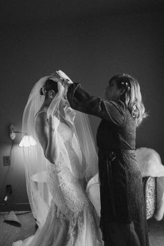 a bride and groom are getting ready for their wedding ceremony in black and white photo