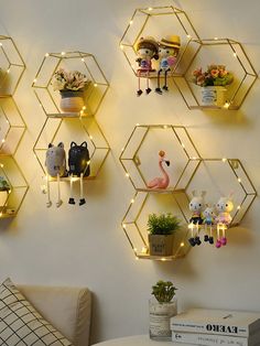 the wall is decorated with gold hexagonal shelves