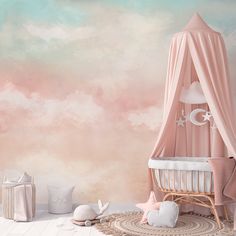 a baby's room with a pink canopy and clouds painted on the wall behind it