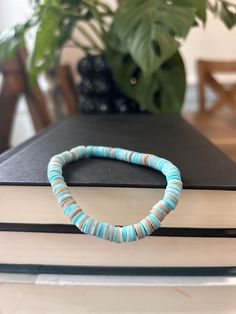 A mix of sand and blue swirls will make you wish you were at the beach. Beach Polymer Clay Bracelets, Clay Bead Surf Necklace, Beach Themed Clay Bead Bracelet, Beach Themed Clay Bracelet, Ocean Bracelet Clay Beads, Clay Beaded Bracelet, Clay Bead Bracelet, Strung Beads, Bracelet Men