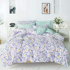 a bedroom with white walls and flowers on the bedspread, along with an open window