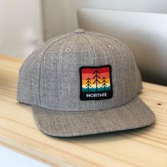 Whether you are strolling along the lakefront, attending a summer festival, or simply soaking in the evening glow, the Northie Snapback Hat is the perfect companion. Featuring a custom iron-on patch and flat bill design, it is sure to become your new go-to accessory. 83/15/2 acrylic/wool/spandex Structured, six-panel, mid-profile Flat bill Moisture-management sweatband Snapback closure Custom Iron On Patches, Bill Design, Panel Hat, Summer Festival, Snapback Hat, Iron On Patches, Heather Gray, Snapback Hats, Heathers