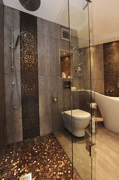 a bathroom with a tub, toilet and shower in it's center wall that has coins all over the floor