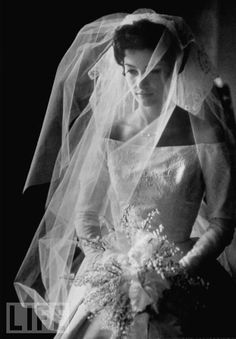 a woman in a wedding dress and veil