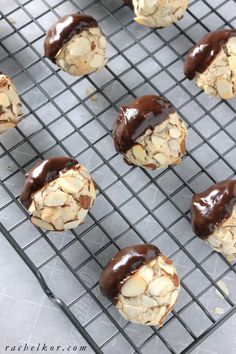 chocolate covered cookies on a cooling rack with nuts and almonds in the middle, ready to be eaten