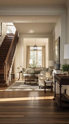 a living room filled with furniture next to a stair case