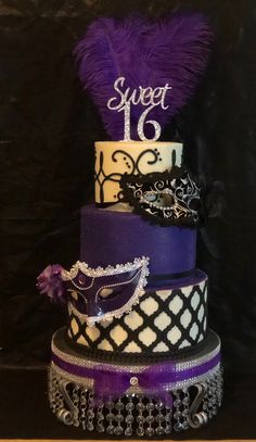 a three tiered cake with purple and white decorations