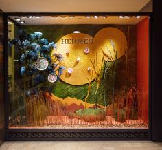 a display case with flowers and leaves on it