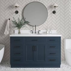 a white toilet sitting next to a bathroom sink under a mirror on top of a counter