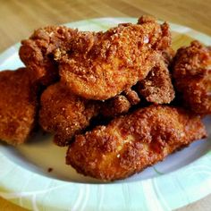 some fried food on a white and green plate