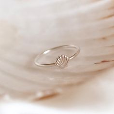 Channel beach vibes whatever the season with our Shell Stacking Ring. The perfect addition to any jewellery box, this simple silver band features a beautifully textured scalloped clam shell to stack high or wear solo. The Seashell symbolises many things across different cultures, including love, peace, fertility, and feminine strength - and will make a meaningful gift for your partner, a friend or even yourself. ~ DESIGN ~ This ring will be made to size for you from 925 sterling silver. The band Minimalist Sterling Silver Jewelry For Beach, Silver Shell Rings For Beach, Silver Shell Rings For Gift, Silver Stackable Jewelry For Beach, Stackable Silver Jewelry For The Beach, Minimalist Silver Rings For The Beach, Minimalist Beach Ring Jewelry, Minimalist Beach Jewelry Ring, Ocean-inspired Silver Rings For The Beach