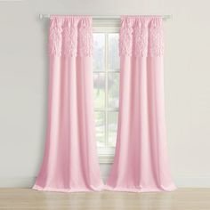 pink curtains with lace trims hanging on a window sill in front of a white wall