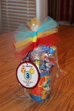 a birthday basket with candy, candies and lollipops in it on a table