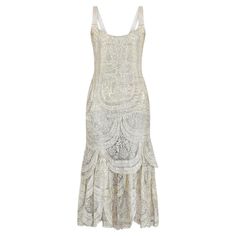 Tailored to a classic 1920s drop-waist silhouette, this is a rare surviving culottes dress from the earlier part of the flapper era and our oldest ever jumpsuit design! This antique piece features wide lame ribbon straps in shimmering silver. Intricate cobweb lame mimics the appearance of lace, with flowers, shell motifs and geometric shapes woven throughout. The top layer is sheer and the dress is lined with champagne silk with hook-and-eye closures at the rear. The bottom layer forms a pair of Fitted Vintage Flapper Dress For Vintage Events, 1920s Style Flapper Dress For Vintage Events, Vintage Fitted Flapper Dress For Cocktail, Fitted Vintage Flapper Dress For Cocktail, Gatsby Style Sleeveless Flapper Dress For Vintage Events, Sleeveless Gatsby Flapper Dress For Vintage Events, Art Deco Sleeveless Dress For Vintage Events, Sleeveless Gatsby Dress For Vintage Events, 1920s Flapper Dress For Summer Formal Events