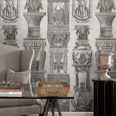 a living room with a couch, chair and wallpaper in black and white colors