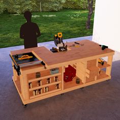 a man standing next to a workbench with tools on it