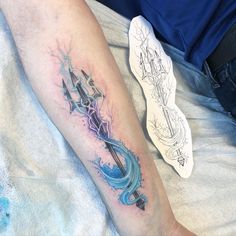 a person with a tattoo on their leg and an arrow in the water behind them