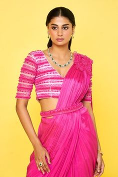 Pink chiffon pre-draped saree with 3D petunia petal embellishment on the shoulder and a pleated drape. Paired with a half sleeves V neck blouse with striped bloom embroidery using tonal sequins, beads, crystal highlights and a petticoat. - Aza Fashions Pink Dola Silk Pre-draped Saree With Cutdana, Designer Pink Pre-draped Saree With Cutdana, Pink Cotton Silk Pre-draped Saree With Cutdana, Embellished Pink Silk Pre-draped Saree, Semi-stitched Embellished Pink Pre-draped Saree, Bloom Embroidery, Draped Saree, Pink 3d, Drape Saree