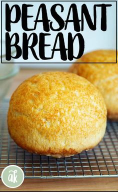 two fresh baked breads sitting on top of a cooling rack next to each other