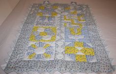 a quilted table runner with yellow and blue designs