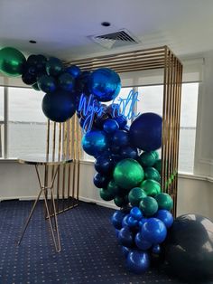 blue and green balloons are on display in an office