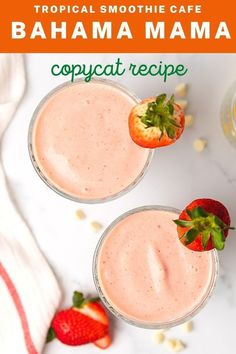 two glasses filled with strawberry smoothie and topped with strawberries