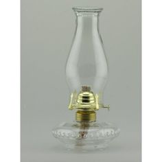 an old fashioned glass oil lamp on a clear base with gold trimmings and a brass spigot