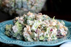 a blue plate topped with broccoli salad