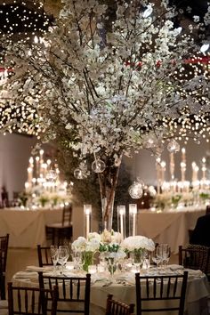 an elegant centerpiece with white flowers and candles