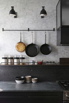 pots and pans are hanging on the wall