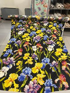 an image of a table cloth with colorful flowers on it in a store display area